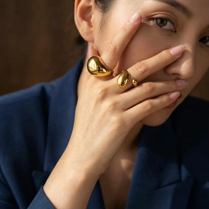 BEHI MILANO Archana Ring — model in navy blazer wearing gold oversized molten dome ring