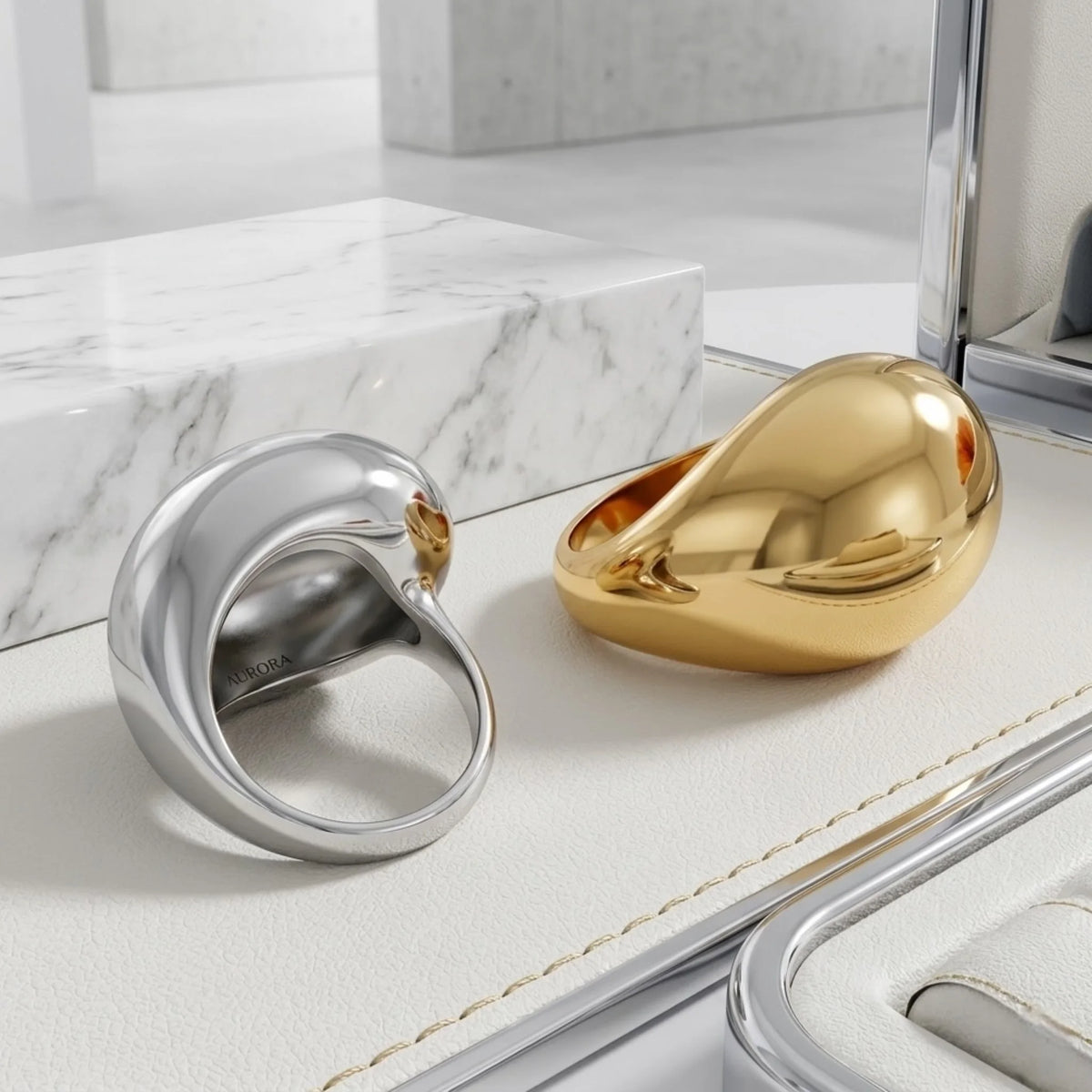 BEHI MILANO Archana Ring — gold and silver oversized liquid dome rings on white marble tray