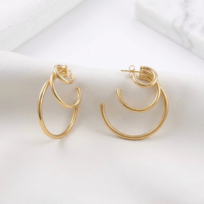 BEHI MILANO Ariel Earrings — 18k gold multi-tier hoops on white draped silk fabric
