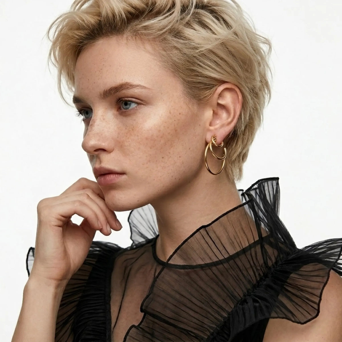 BEHI MILANO Ariel Earrings — model with short hair in sheer black top wearing gold triple hoop earrings