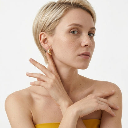 BEHI MILANO Aris Earrings — portrait of model wearing 18k gold croissant zircon studs