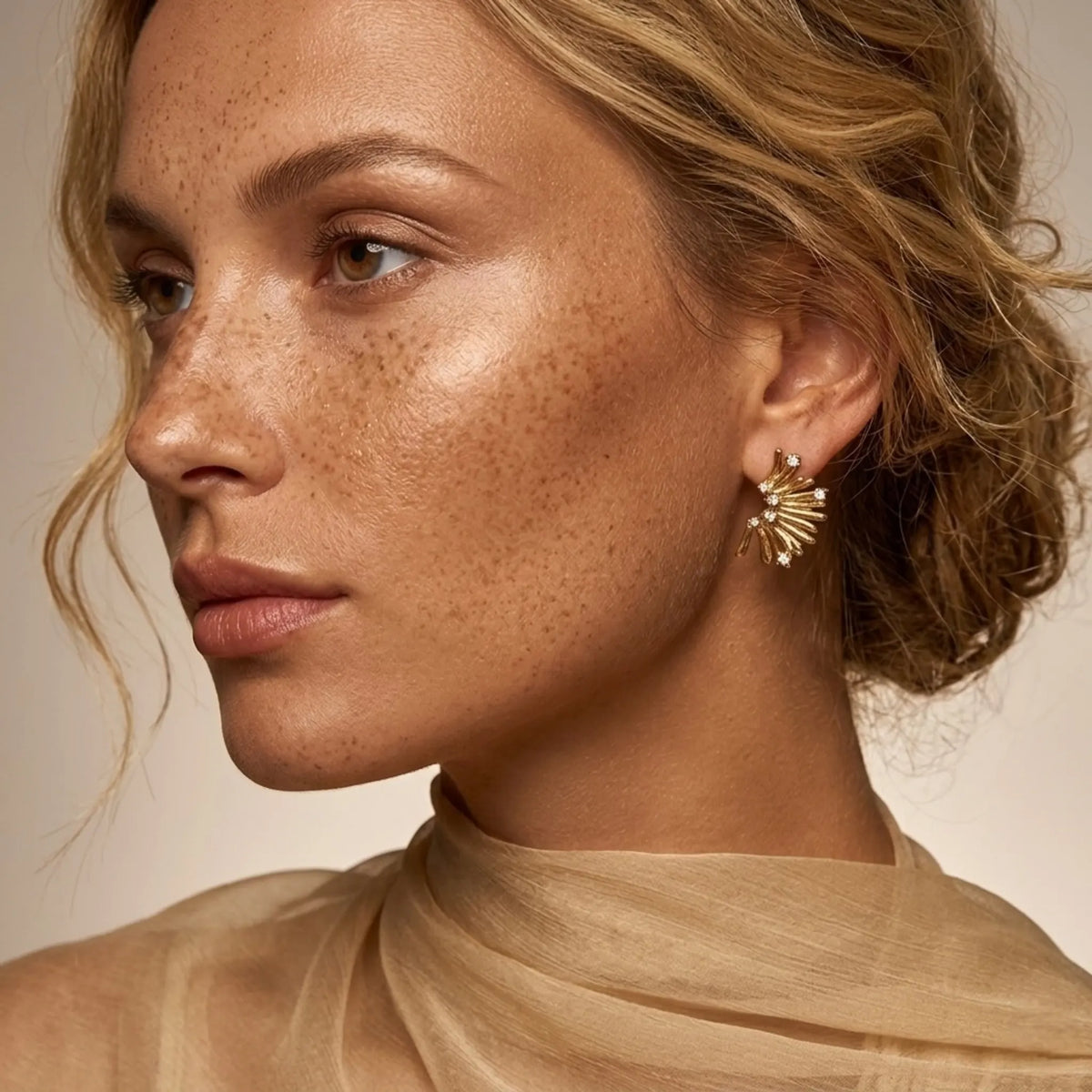 BEHI MILANO Artyman Earrings — close-up of model wearing gold fan burst zircon earring on ear