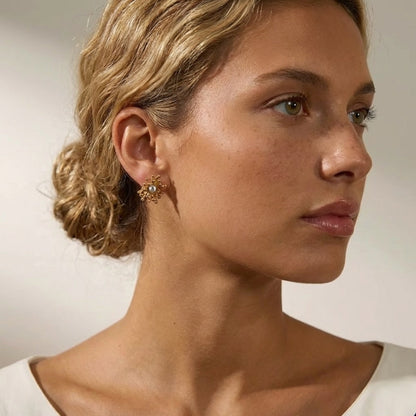 BEHI MILANO Artymanos Earrings — side profile of model with low bun wearing 18k gold statement studs