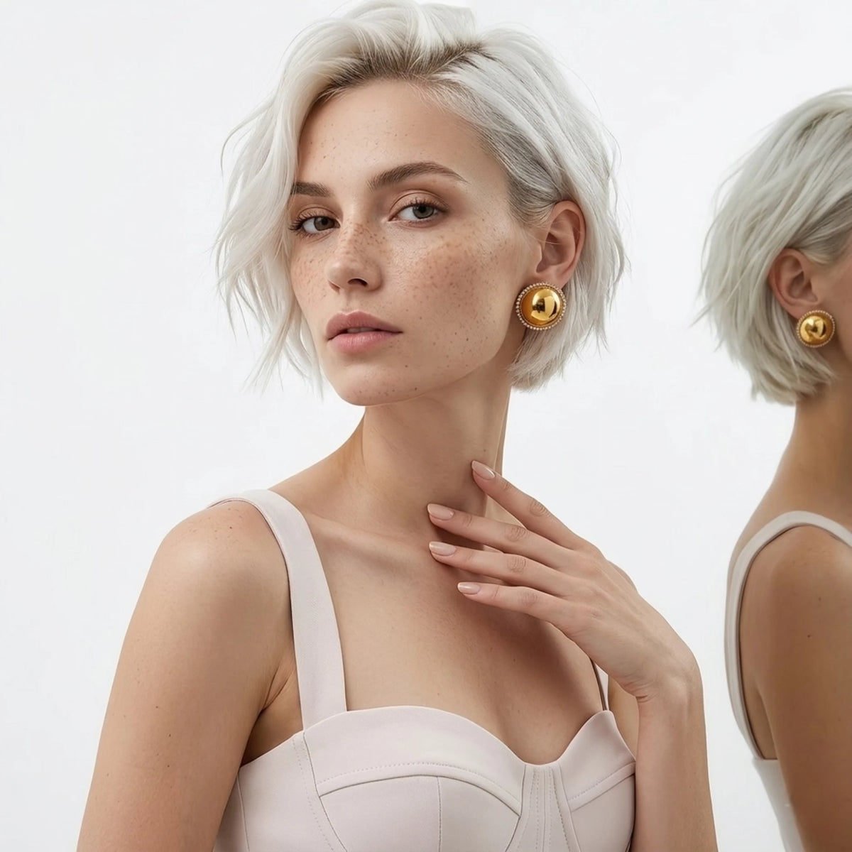 BEHI MILANO Audrey Earrings — platinum blonde model wearing large gold dome halo stud earrings