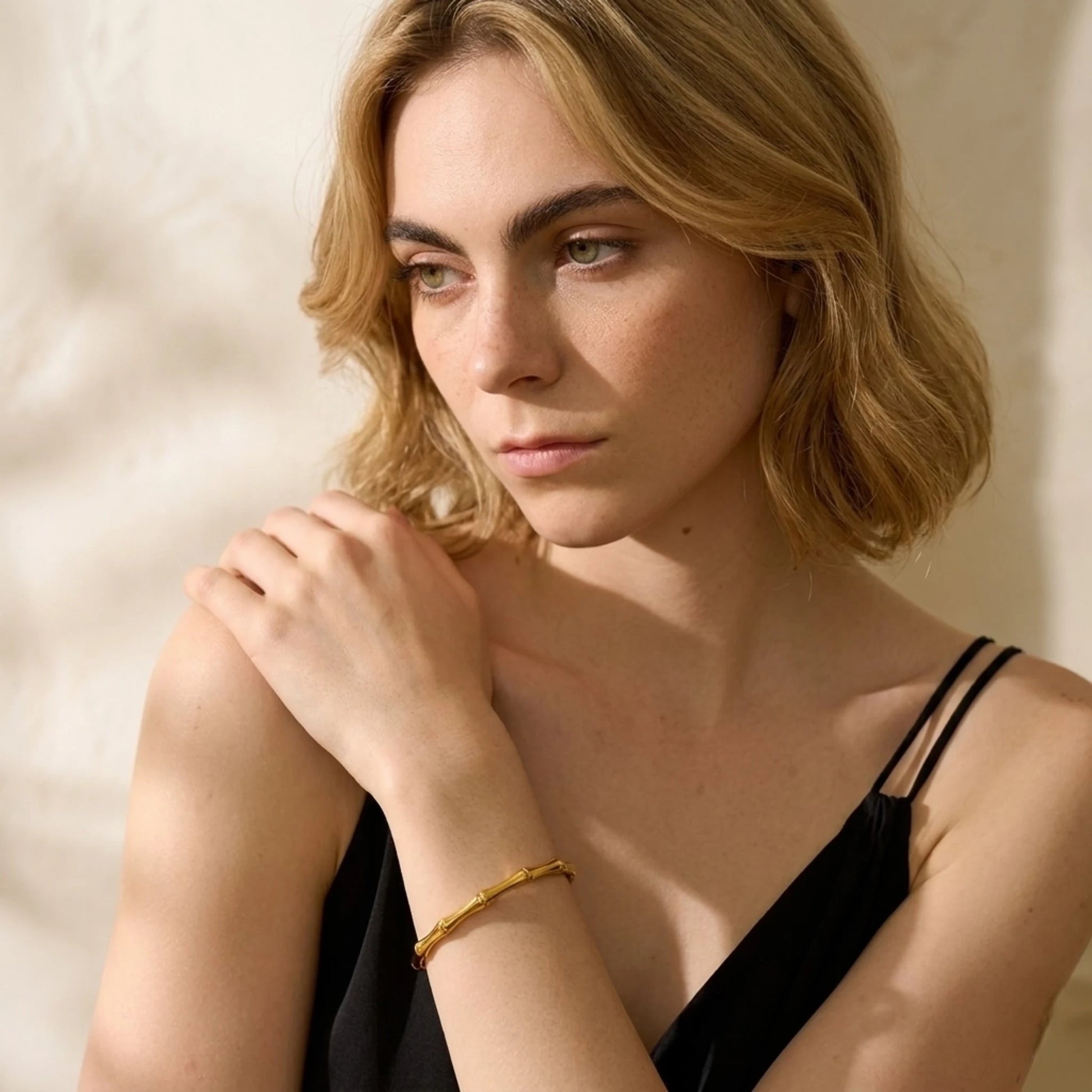 BEHI MILANO Bamboo Bracelet — model wearing gold organic bamboo cuff bracelet on wrist