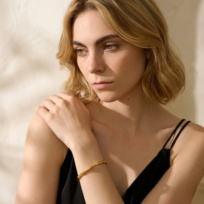 BEHI MILANO Bamboo Bracelet — model wearing gold organic bamboo cuff bracelet on wrist