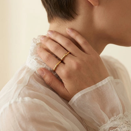 BEHI MILANO Bamboo Ring — model wearing thin gold bamboo ring on finger with white lace