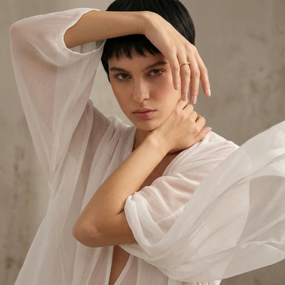 BEHI MILANO Bamboo Ring — portrait of model in sheer white blouse wearing 18k gold bamboo ring