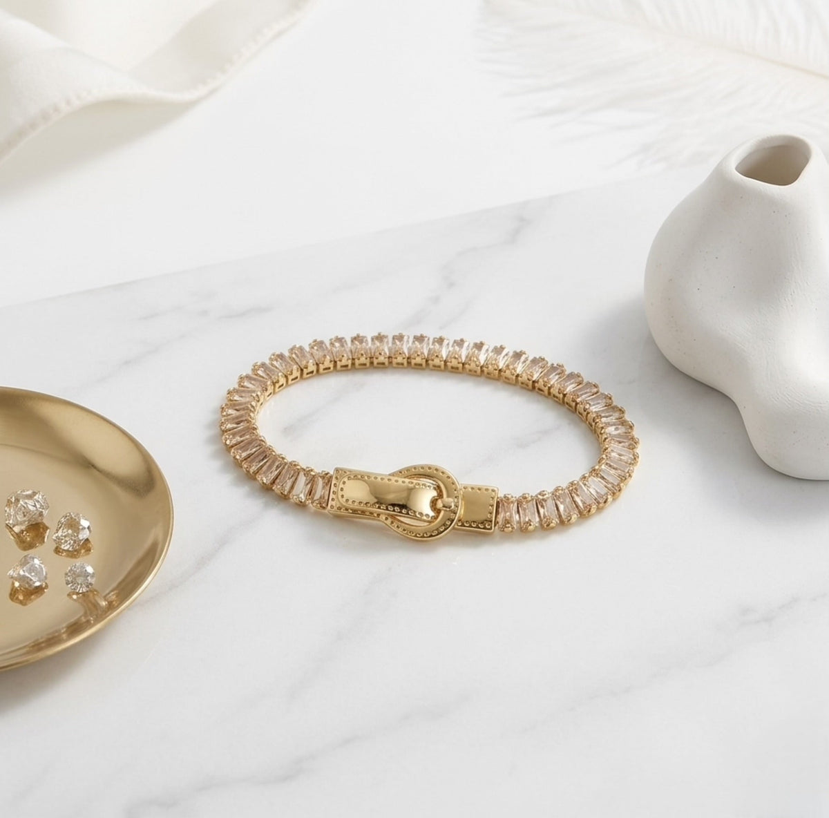 BEHI MILANO Beatrice Bracelet in Champagne — gold gemstone magnetic bracelet displayed on white marble tabletop