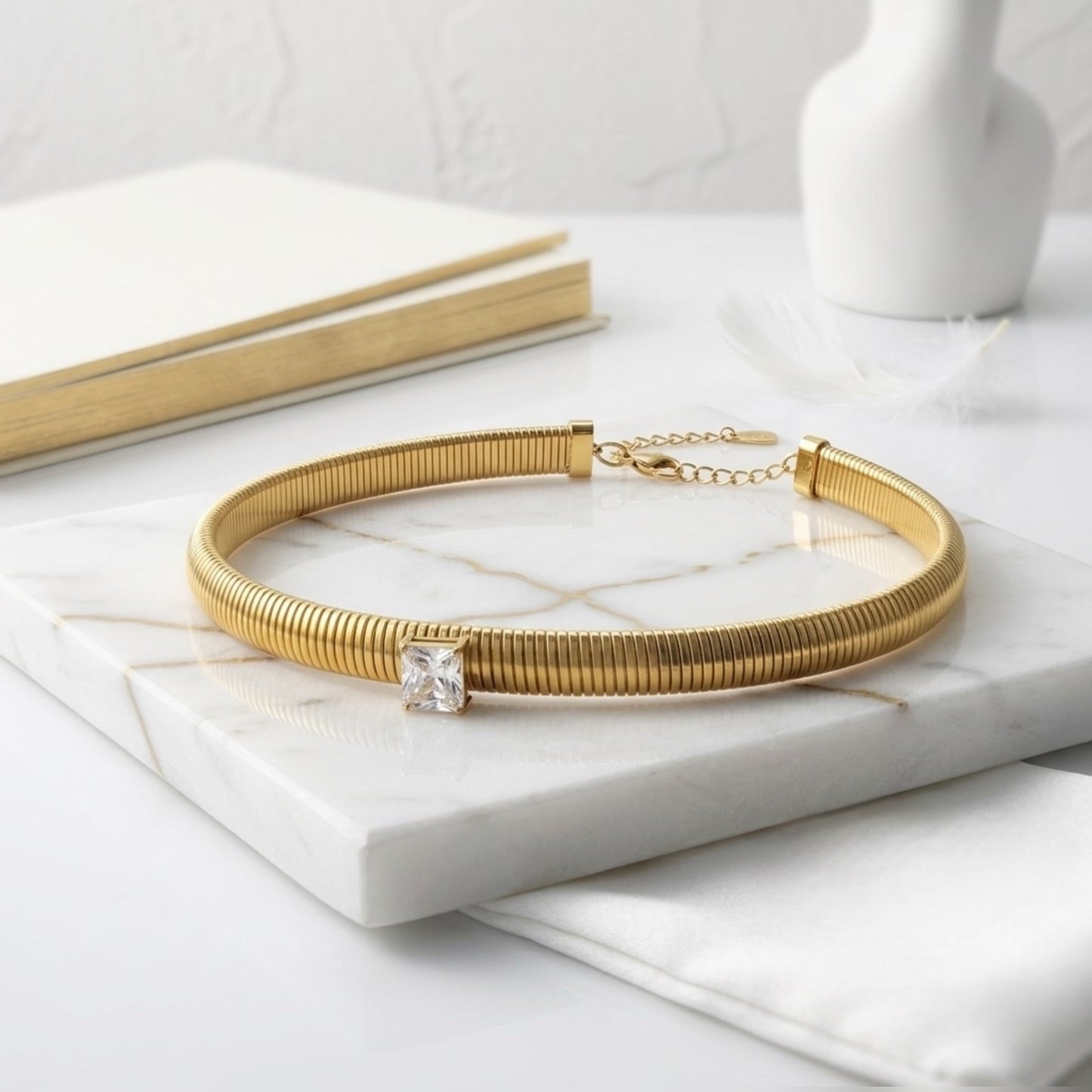BEHI MILANO Beatriz Choker in Gold — gold ribbed choker displayed on white marble tabletop