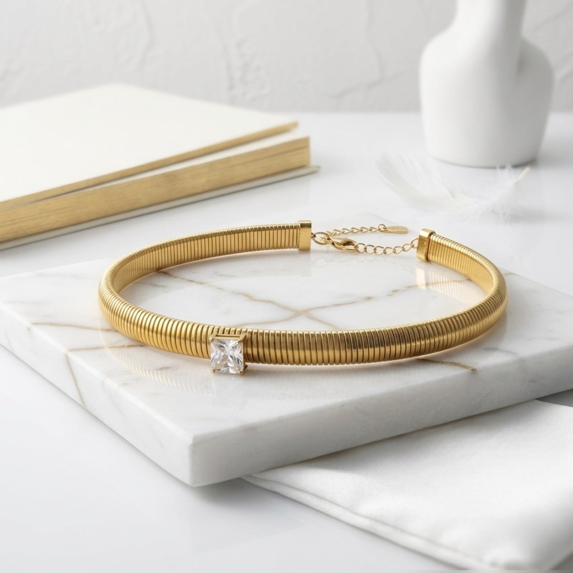 BEHI MILANO Beatriz Choker in Gold — gold ribbed choker displayed on white marble tabletop