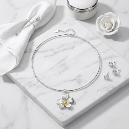 BEHI MILANO Bloom Choker — floral wire choker necklace displayed on white marble with white roses