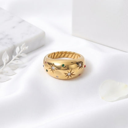 BEHI MILANO Camila Ring — 18k gold dome star ring resting on white satin cloth
