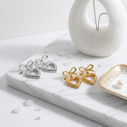 BEHI MILANO Cara Earrings — silver and 18k gold ribbon bow heart drop earrings pair display