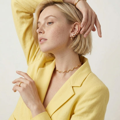 BEHI MILANO Carla Choker — model wearing 18k gold wavy cuff necklace with tailoring