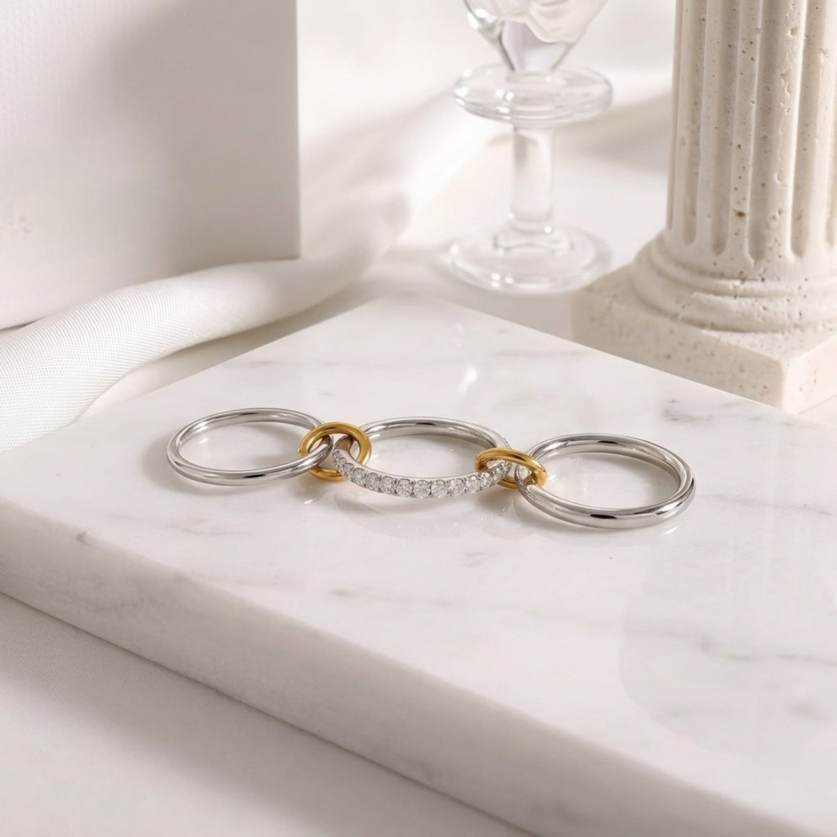 BEHI MILANO Carlita Ring — 3 connected pave and polished bands displayed flat on white marble table