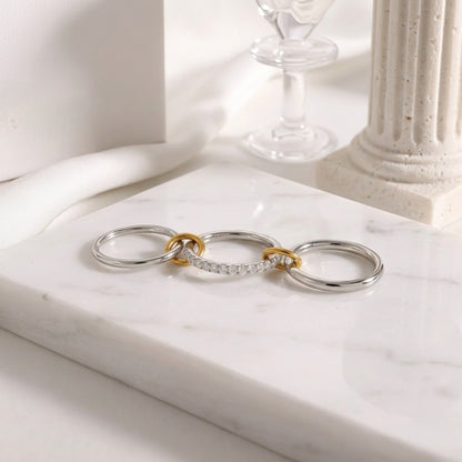 BEHI MILANO Carlita Ring — 3 connected pave and polished bands displayed flat on white marble table