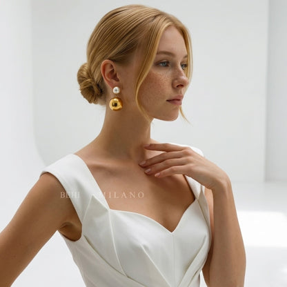 BEHI MILANO Carollina Earrings — model with blonde updo wearing gold sphere pearl statement earrings