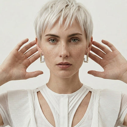BEHI MILANO Cindy Earrings — frontal portrait of model wearing two-tone architectural drop studs