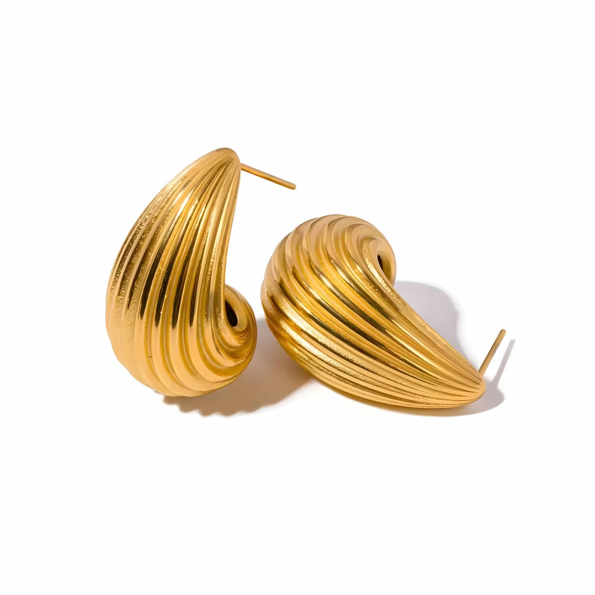 BEHI MILANO Claire Earrings — 18k gold-plated ribbed croissant drop stud earrings on white background