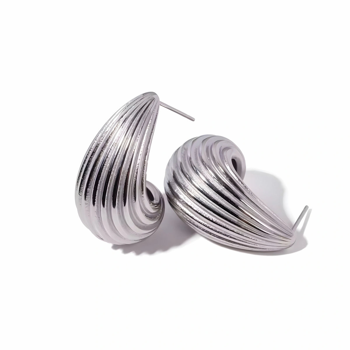 BEHI MILANO Claire Earrings — silver-tone stainless steel ribbed drop stud earrings on white background
