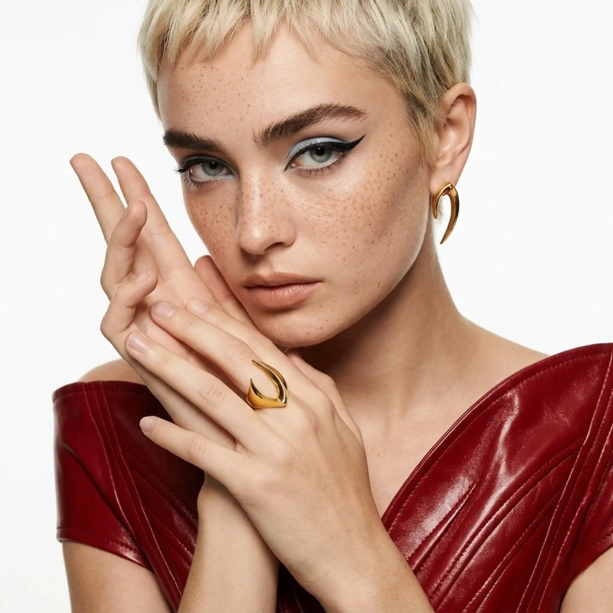 BEHI MILANO Clarissa Ring — model with short blonde crop hair wearing gold blade ring and red outfit