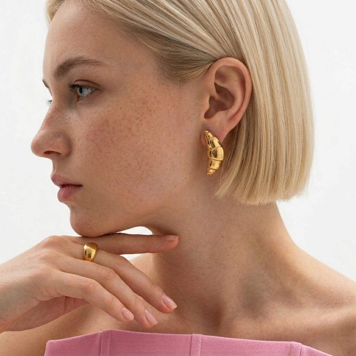 BEHI MILANO Cornetto Earrings — side profile of blonde model wearing 18k gold croissant drop earrings
