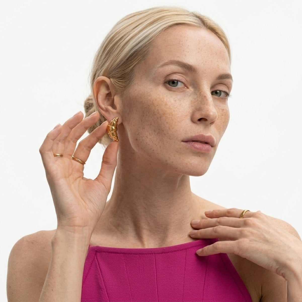 BEHI MILANO Cornetto Earrings — front view of model touching ear wearing gold Italian cornetto studs