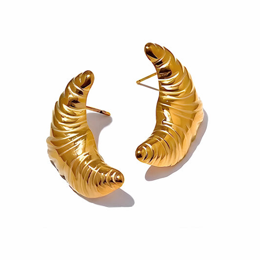 BEHI MILANO Croissant Earrings — 18k gold-plated ribbed crescent drop stud earrings on white background