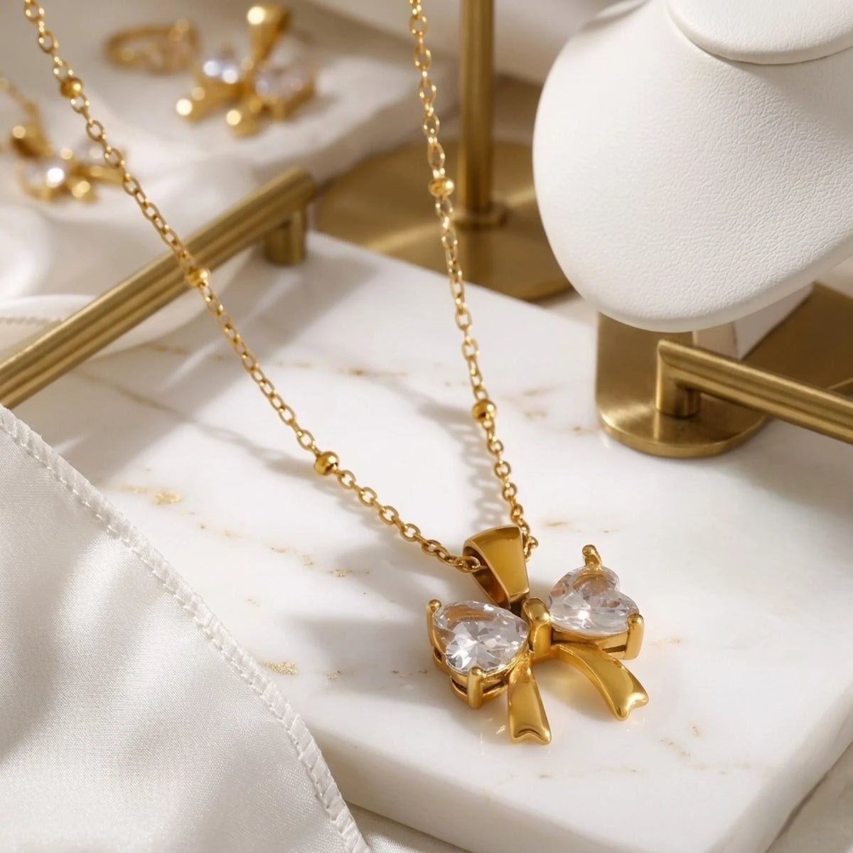 BEHI MILANO Dalia Necklace — gold beaded satellite chain with pendant displayed on white marble slab