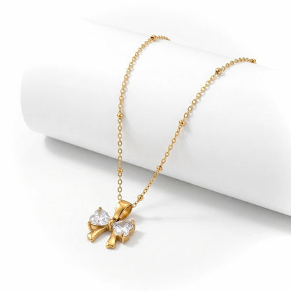BEHI MILANO Dalia Necklace — 18k gold beaded satellite chain with zircon butterfly pendant on white stand