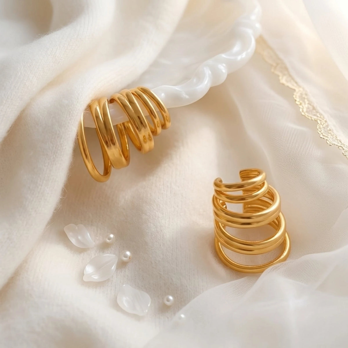 BEHI MILANO Denyse Ear Cuffs — gold spiral ear cuffs on white silk cloth with pearls