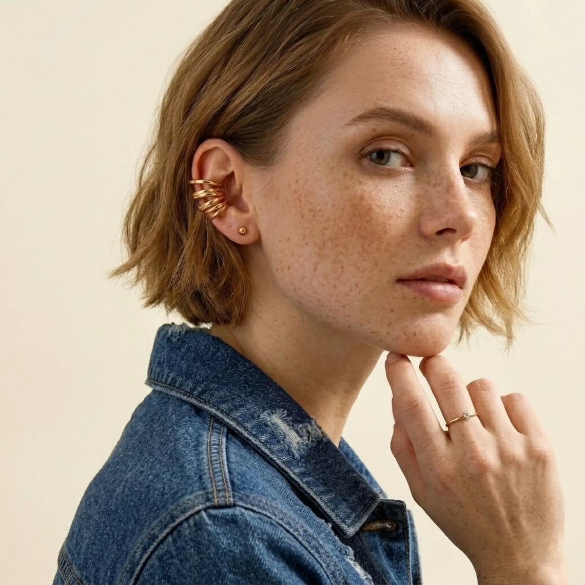 BEHI MILANO Denyse Ear Cuffs — close-up of non-pierced gold stacked helix ear cuff on ear