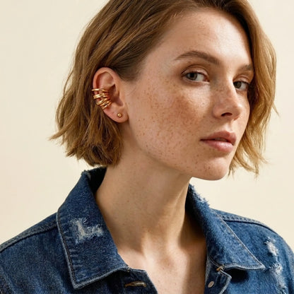 BEHI MILANO Denyse Ear Cuffs — model wearing gold multi-band spiral ear cuff on cartilage with denim jacket