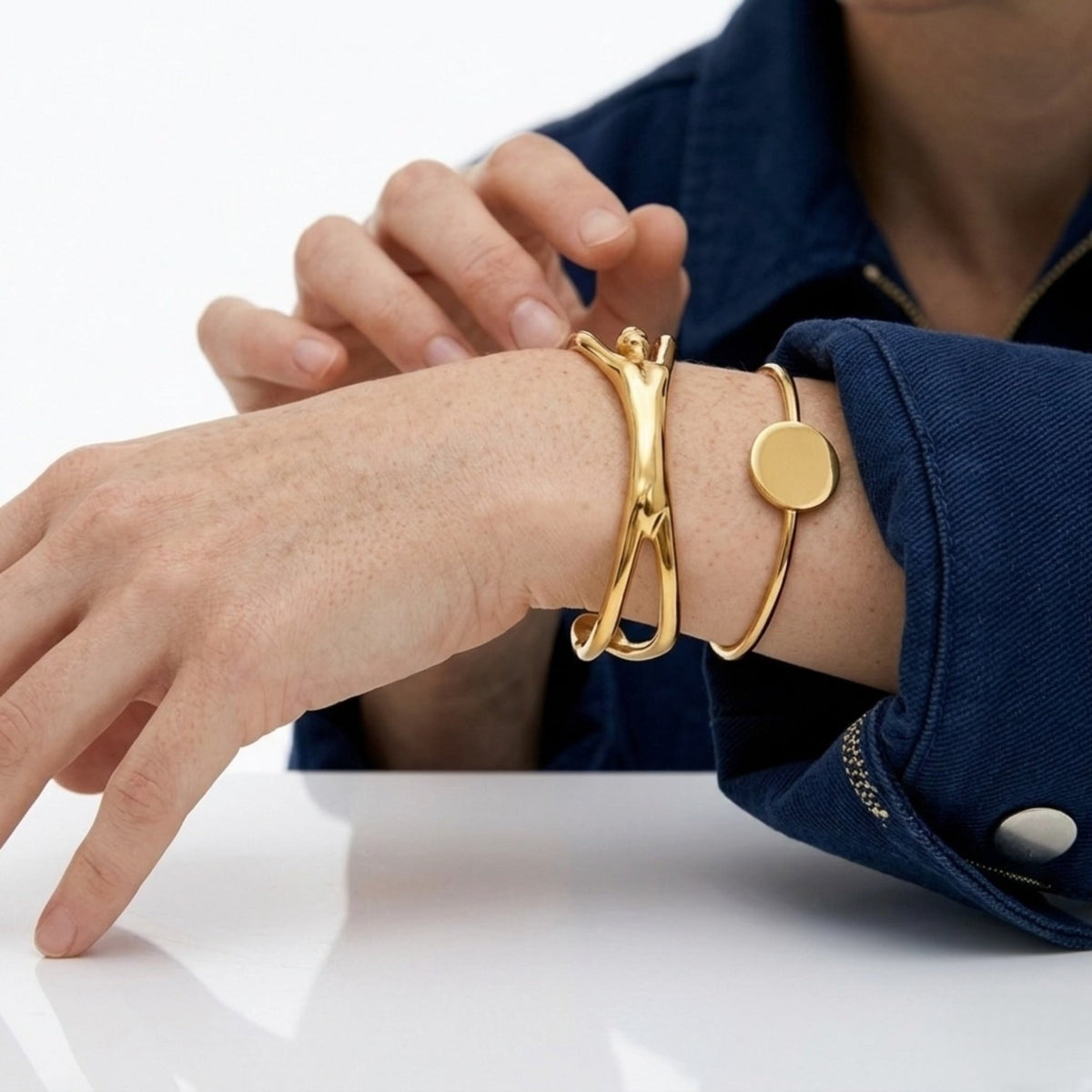 BEHI MILANO Devika Bracelet — close-up of gold abstract body line cuff on model wrist