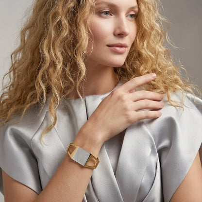 BEHI MILANO Dimitra Bracelet — model wearing gold and silver geometric cuff bracelet with grey top