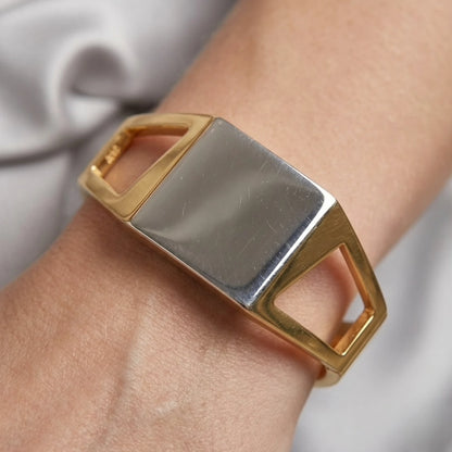 BEHI MILANO Dimitra Bracelet — close-up of gold and silver two-tone cuff bracelet on wrist