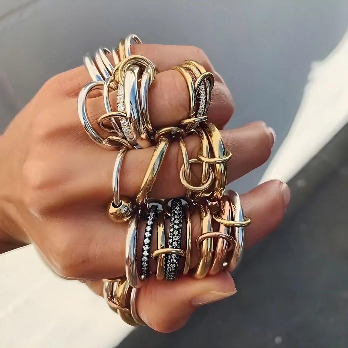 BEHI MILANO Dori Ring — close-up of intricate gold and pearl ring stacked with other gold rings