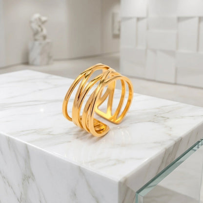 BEHI MILANO Eden Ring — gold open-back ring placed on marble block stand