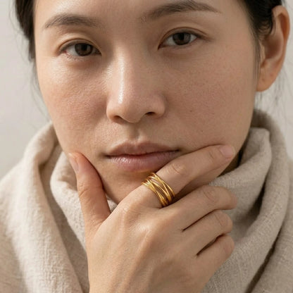 BEHI MILANO Eden Ring — close-up portrait of model displaying open gold statement ring