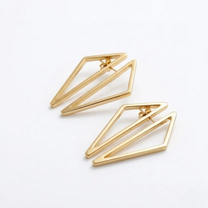 BEHI MILANO Elif Earrings — overhead shot of 18k gold polygonal geometric open framework earrings