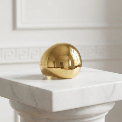 BEHI MILANO Elika Ring — gold spherical sculptural ring resting on miniature marble pillar