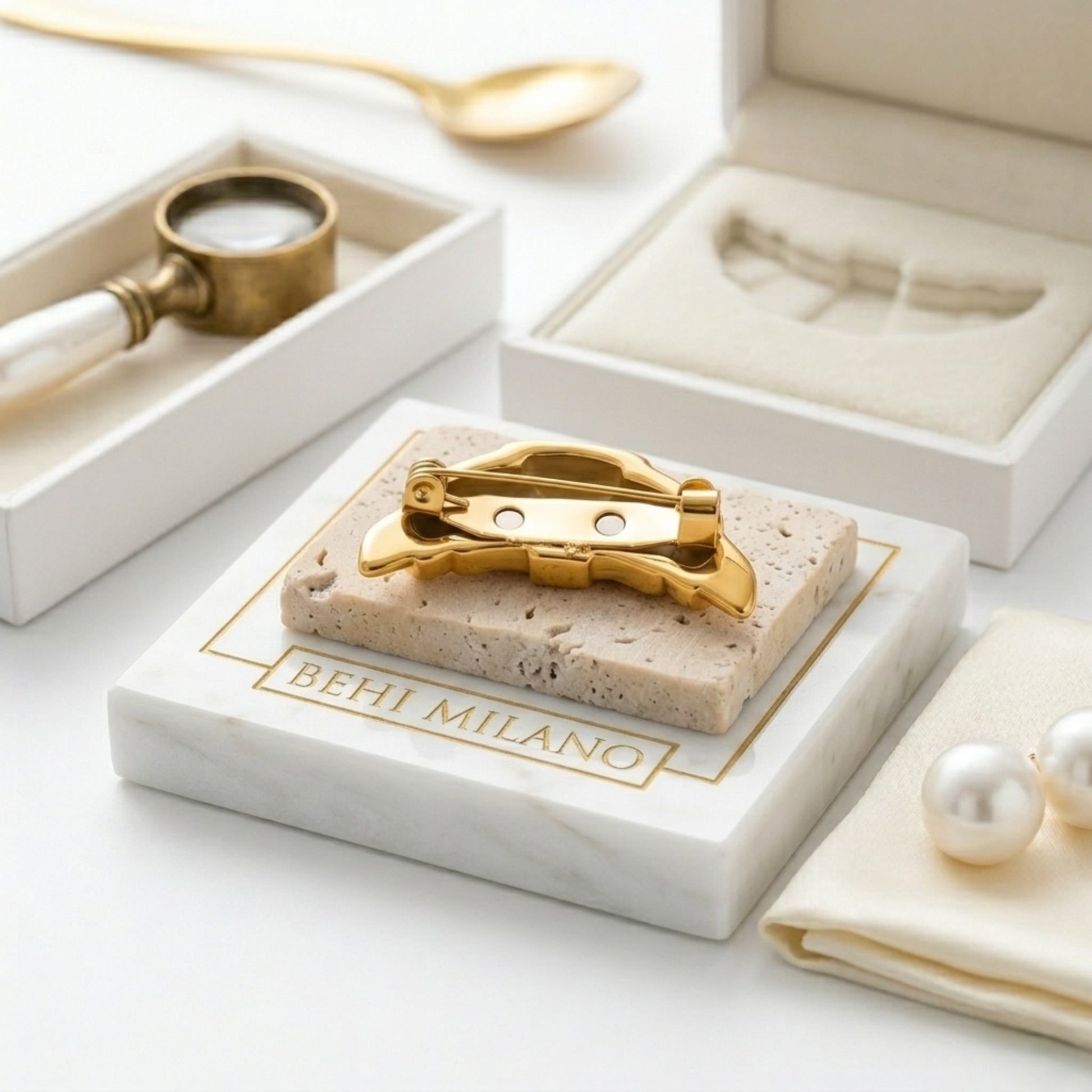 BEHI MILANO Elisa Brooch — back side view showing pin clasp mechanism on marble stand