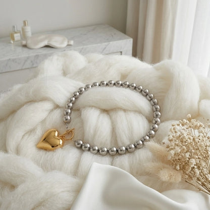 BEHI MILANO Emma Choker — full view of silver sphere beaded necklace on white knitted surface