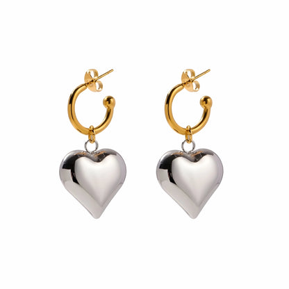BEHI MILANO Emma Earrings — gold hoop earrings with silver puffy heart drop charms on white background