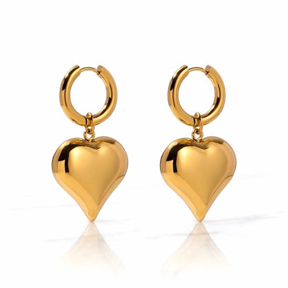 BEHI MILANO Emma Hoop Earrings — 18k gold puffy heart drop huggie hoop earrings on white background