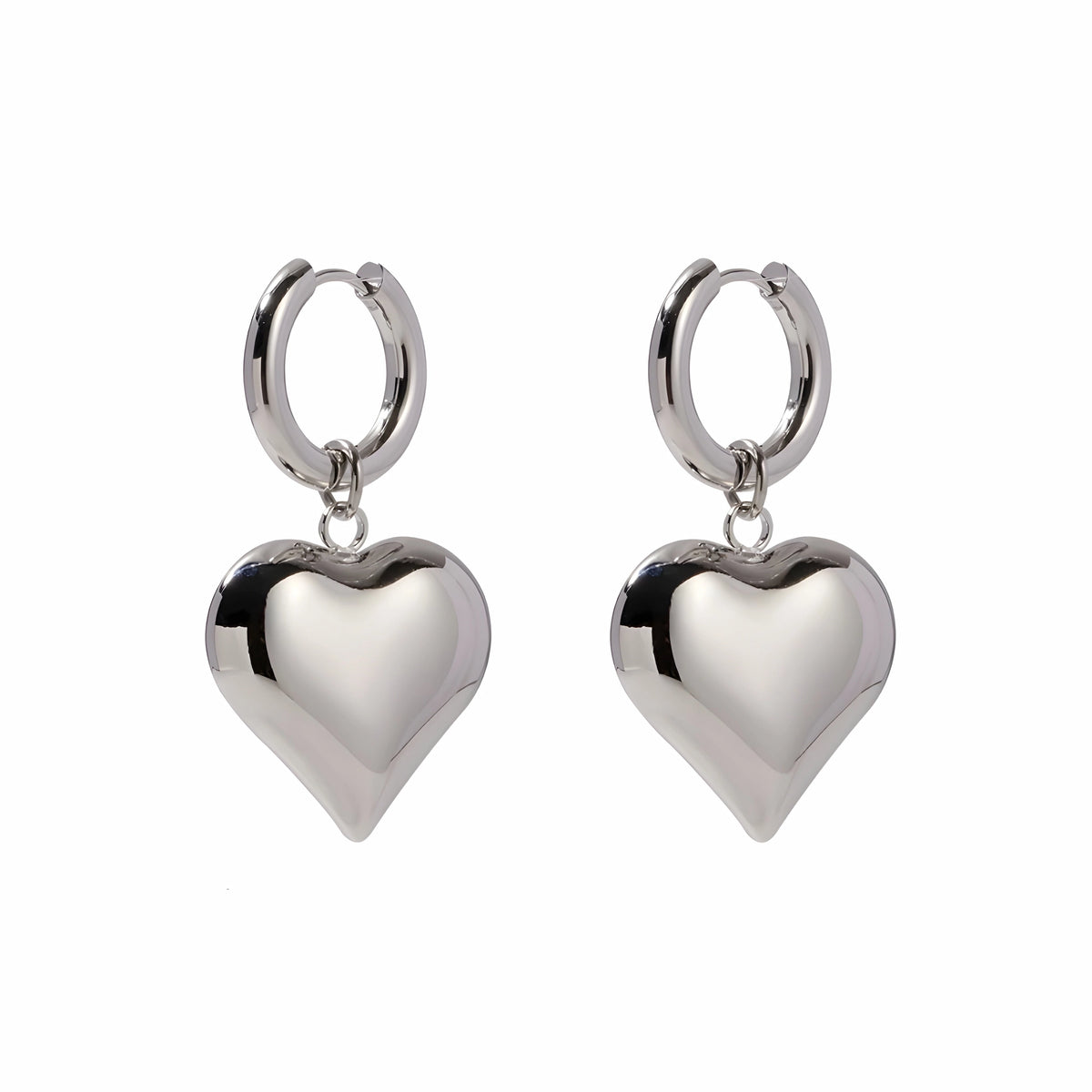 BEHI MILANO Emma Hoop Earrings — silver puffy heart drop huggie hoop earrings on white background