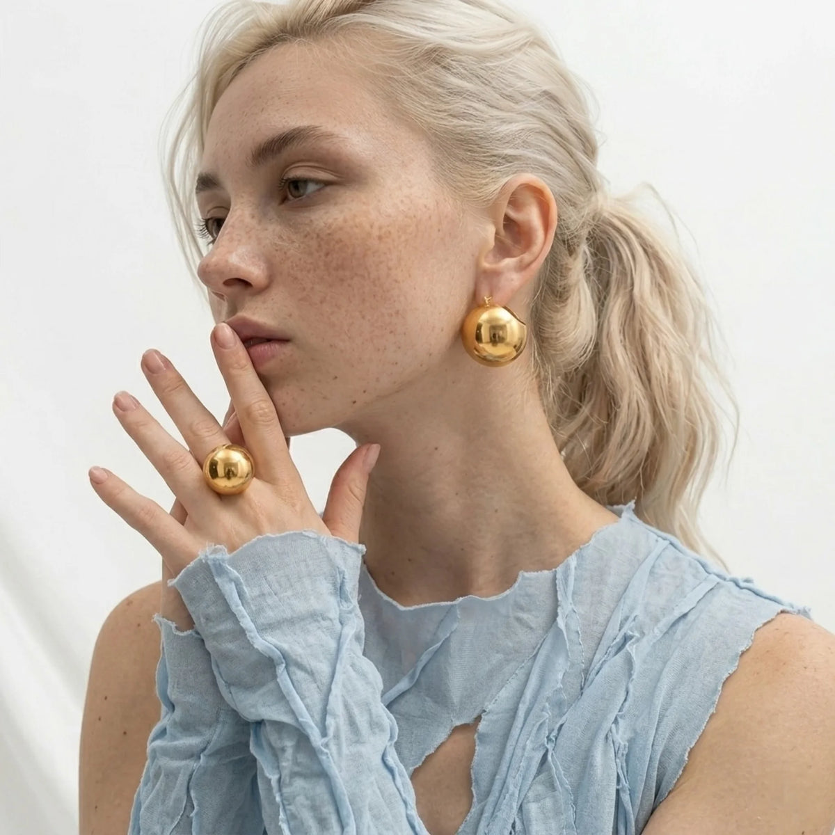 BEHI MILANO Erika Earrings — model wearing 18k gold mirror-finish sphere dome earrings