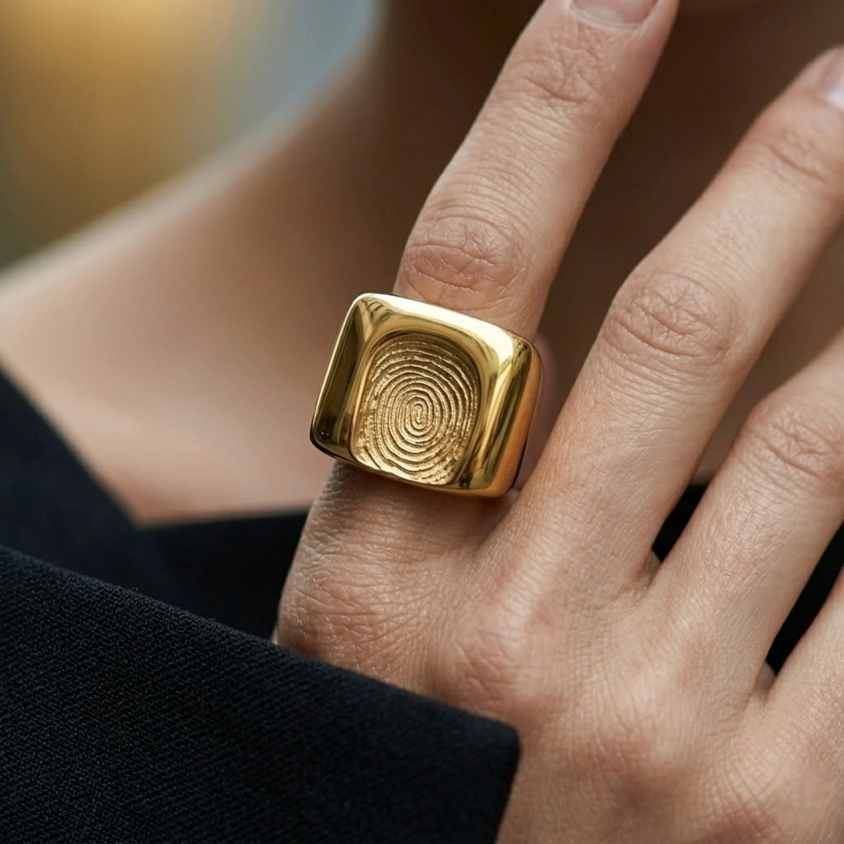 BEHI MILANO Fingerprint Ring — close-up of model hand wearing gold square fingerprint signet ring