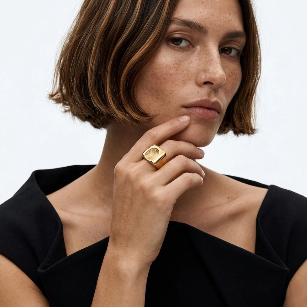 BEHI MILANO Fingerprint Ring — brunette model in black top wearing 18k gold statement ring